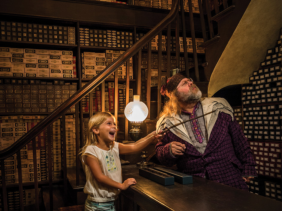 Girl casting spell at Ollivanders in The Wizarding World of Harry Potter