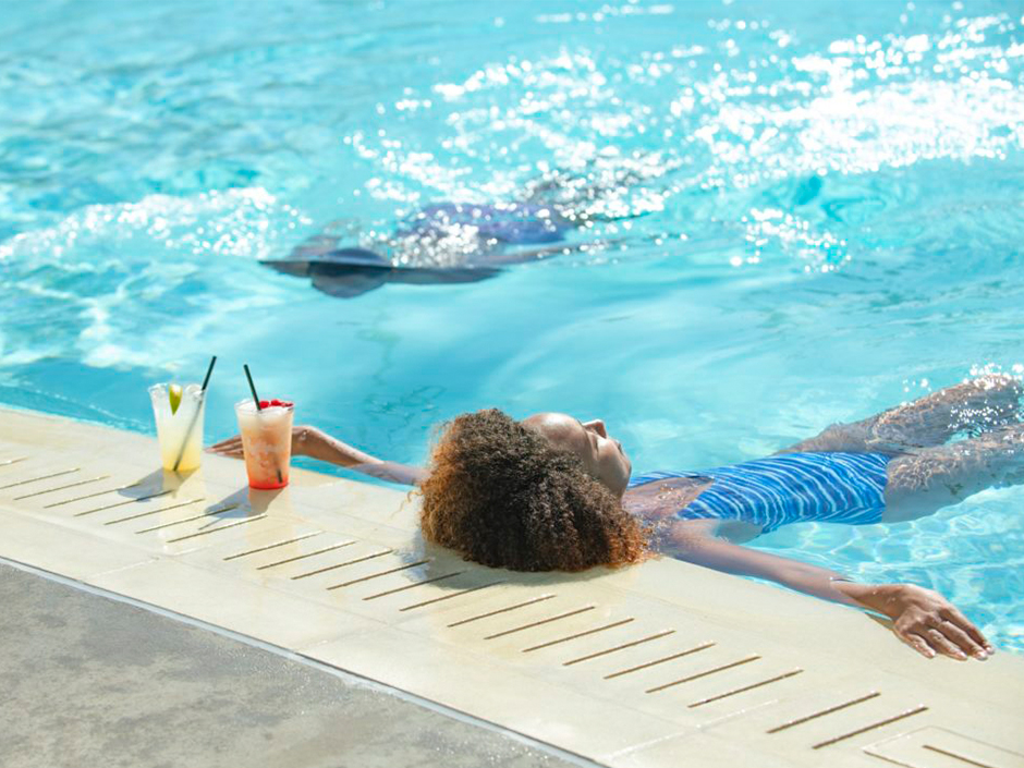 Woman lounging in the pool at Universal Aventura Hotel.
