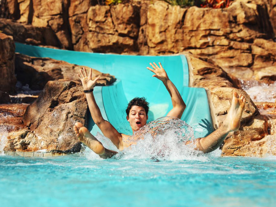 Man sliding down the waterslide at Loews Sapphire Falls Resort.