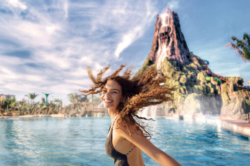A girl laughs at the camera in front of Krakatau volcano at Volcano Bay