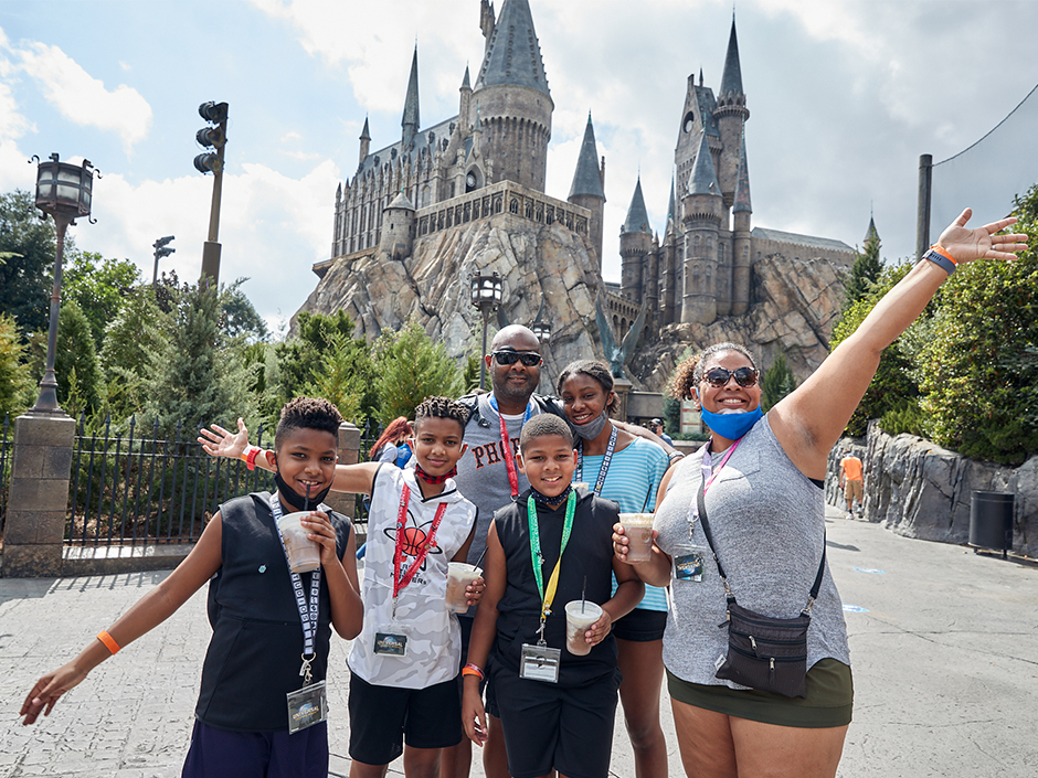 A family in front of Hogwarts Castle