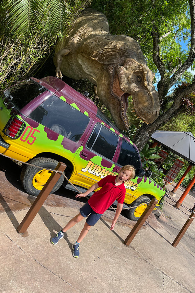 A child in front of a dinosaur photo-op