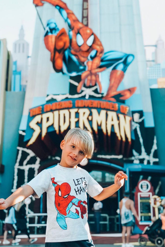 A young child in front of Spider-Man
