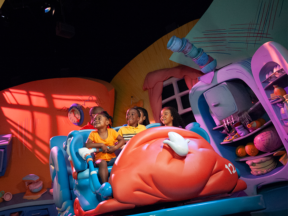 A group of children on the Cat in the Hat attraction