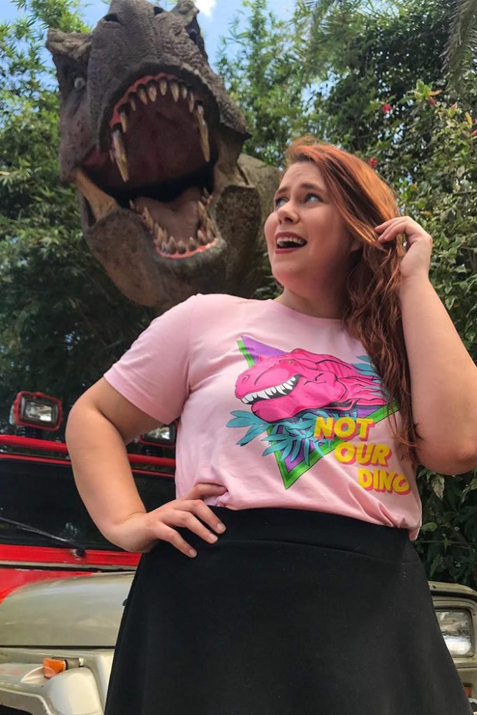 Guest in front of SUV and T. rex