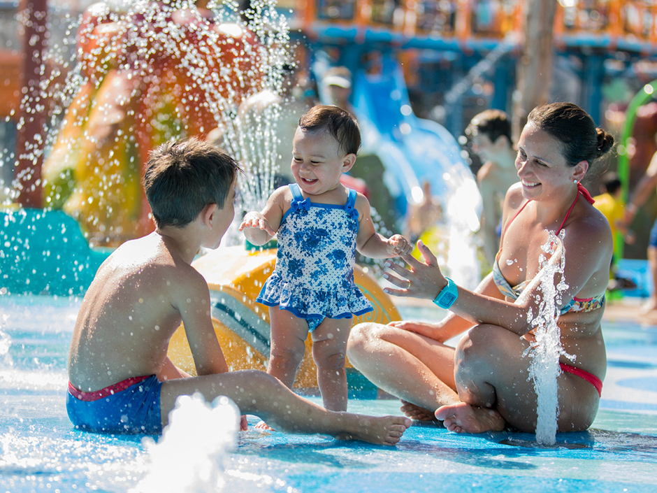 Mother and two kids on the Splash Pad at Volcano Bay