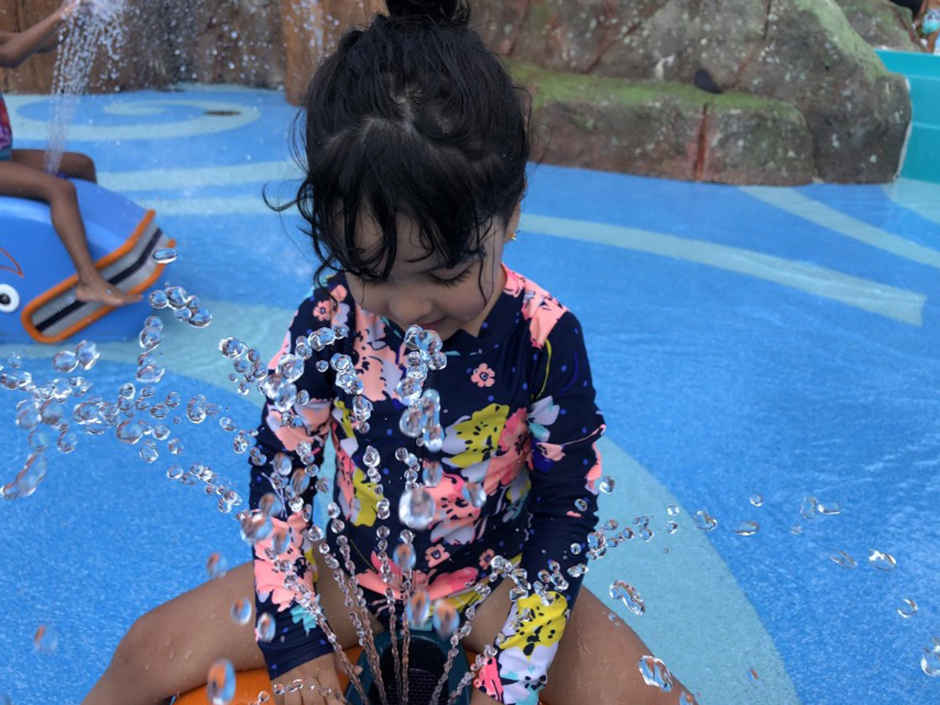 Toddler playing at Volcano Bay Splash Pad