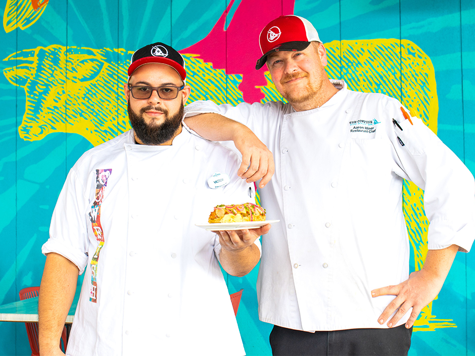 Chefs holding UOAP dish with Cowfish backdrop