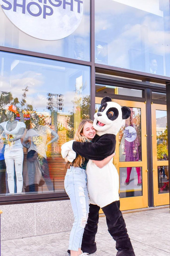 Guest hugging Hashtag Panda Tonight Shop