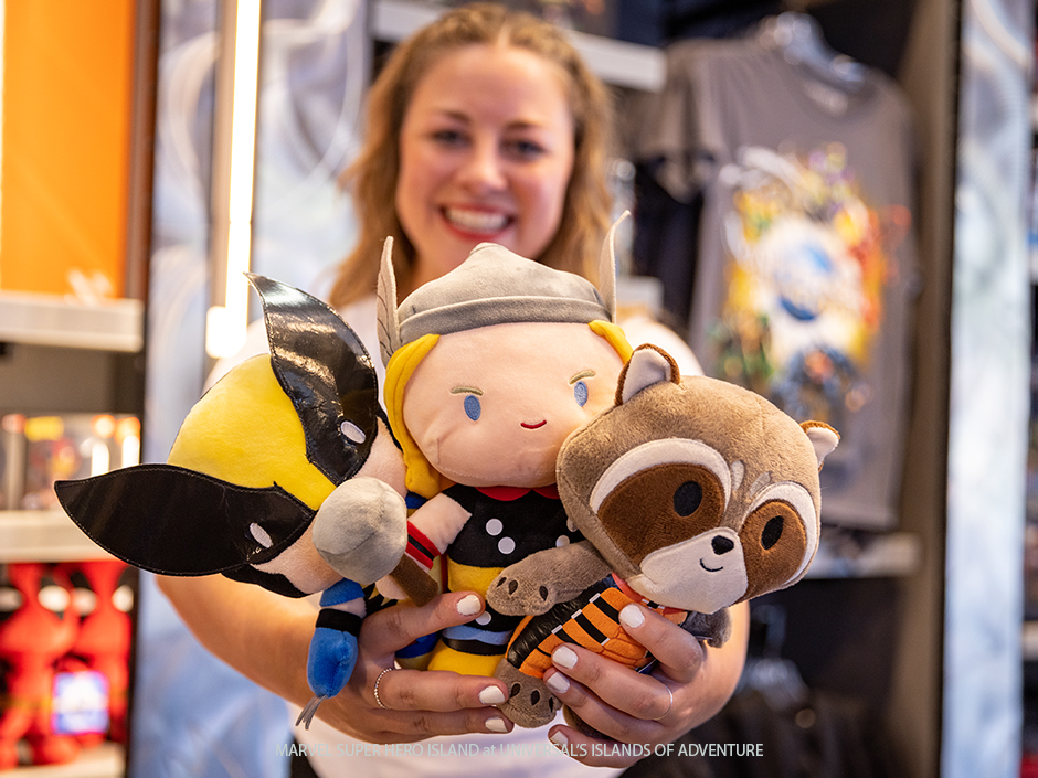 Woman holding out Wolverine Thor Rocket Plush Marvel