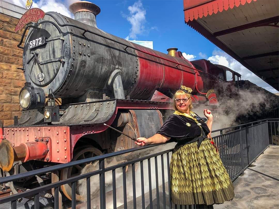 Hufflepuff Standing in Hogsmeade Station with Hogwarts Express behind her