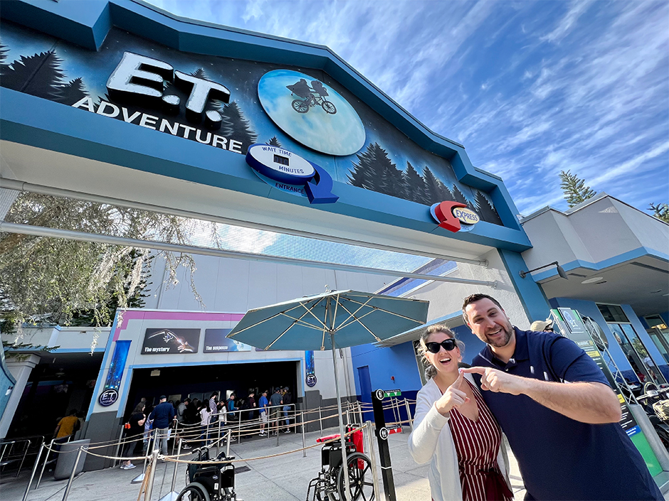 Man and woman standing outside of ET Adventure at Universal