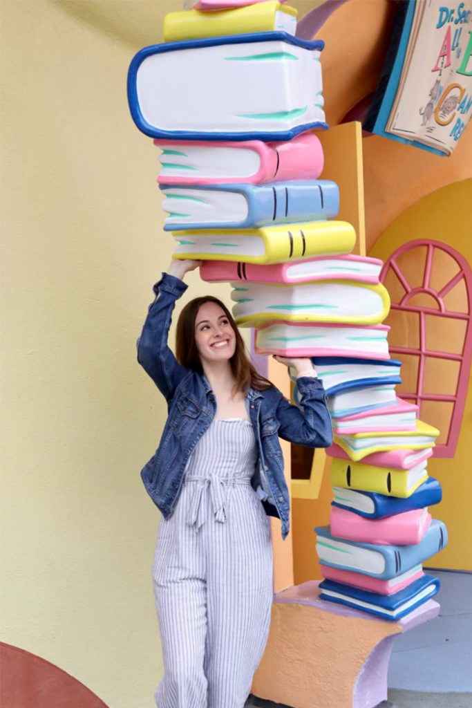 Woman posing with books in Seuss Landing