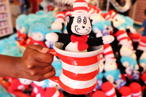Hand holding Cat in the Hat mug with Cat in the Hat plush inside