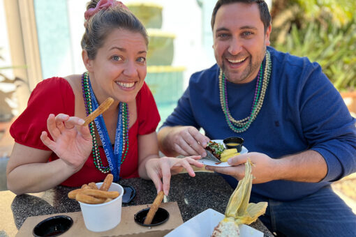 Man and woman eating vegan churros
