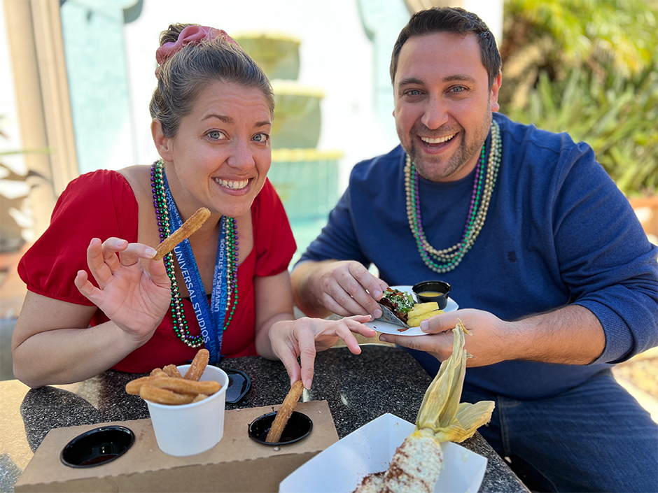 Man and woman eating vegan churros