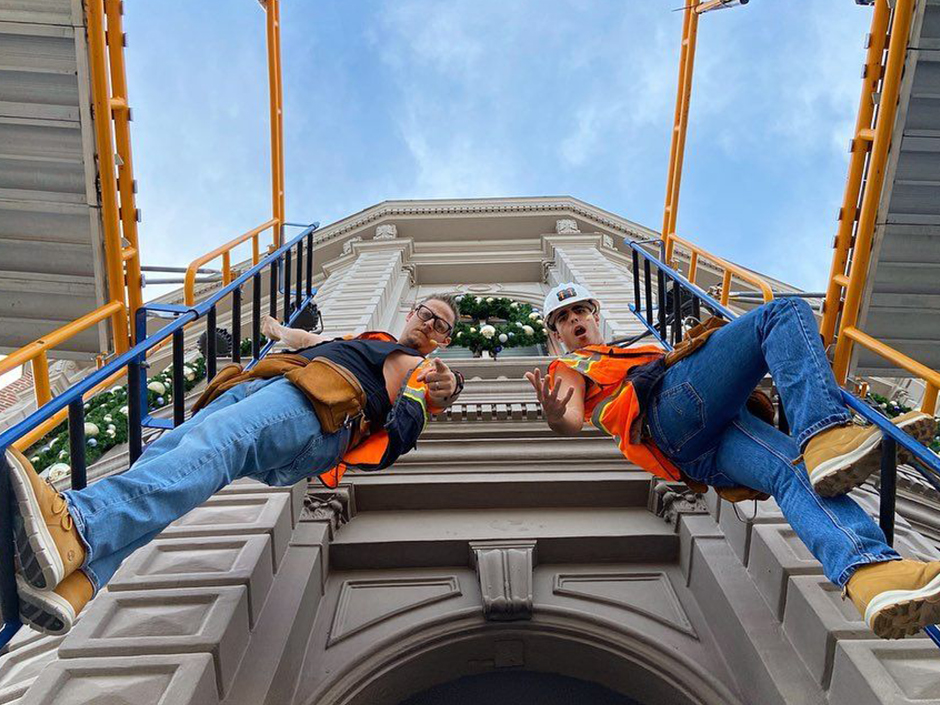 Two construction workers on crane