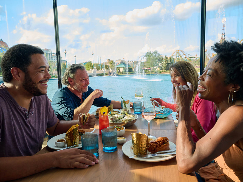 Four friends dining together at Atlantic in Universal Epic Universe