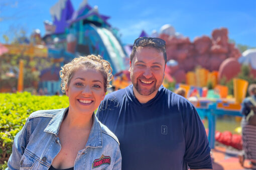 Man and a woman standing in front of Dudley Do Right's water ride at Universal Islands of Adventure