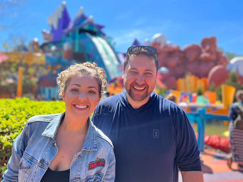 Man and a woman standing in front of Dudley Do Right's water ride at Universal Islands of Adventure