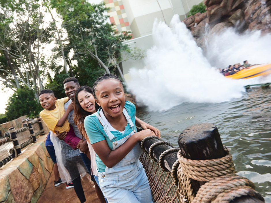 A family laughs in the splash zone of Jurassic Park River Adventure at Universal Islands of Adventure