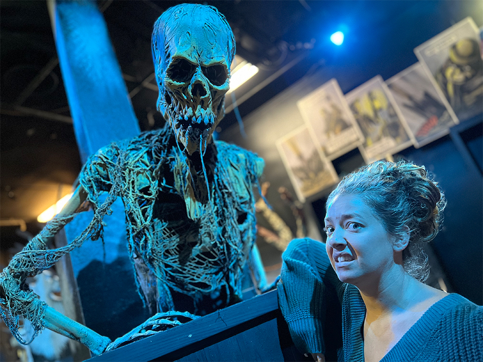 Woman standing in front of skeletal statue at Universal Studios