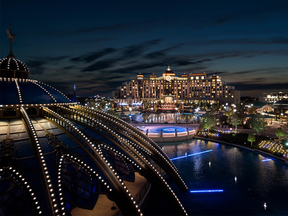 A photo of Celestial Park at night with Helios Grand Hotel in the distance