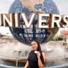 Woman wearing black shirt posing in front of the Universal Orlando globe