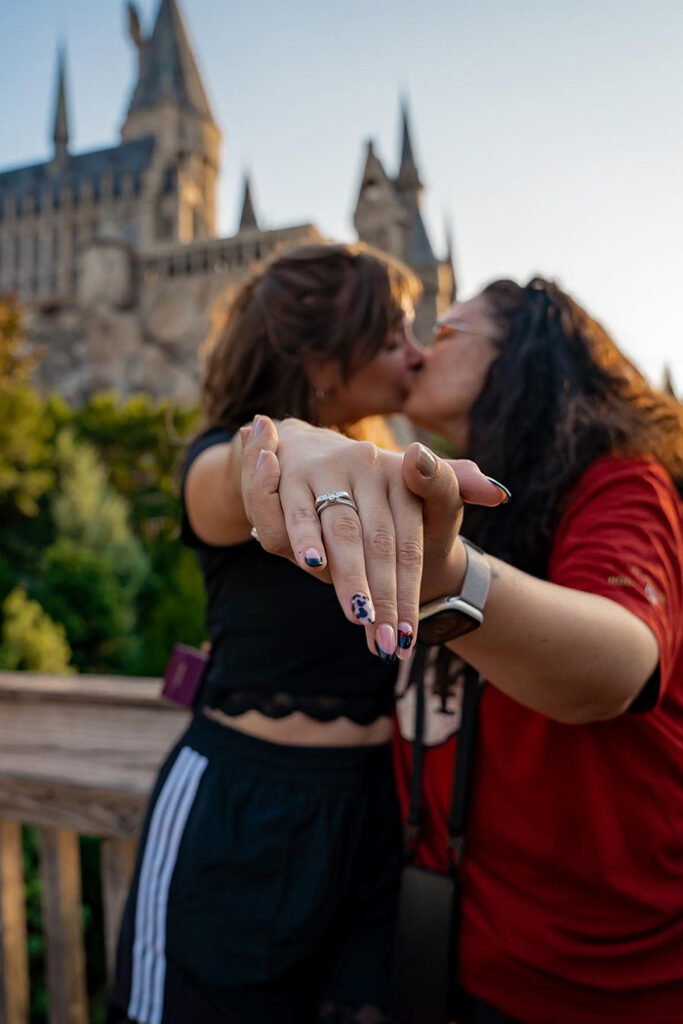 A couple kisses in front of Hogwarts Castle