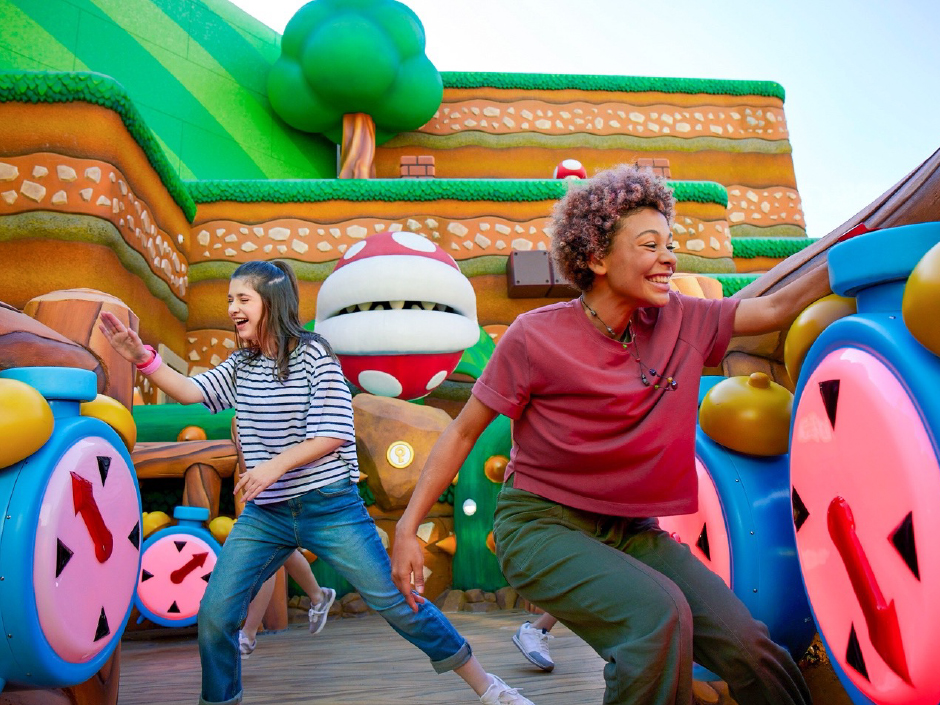 Two people are participating in one of the challenges in Super Nintendo World