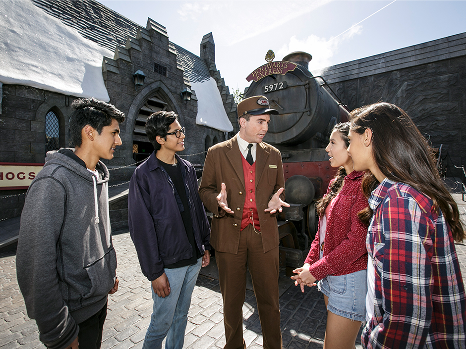 Four guests chat with the conductor of the Hogwarts Express.