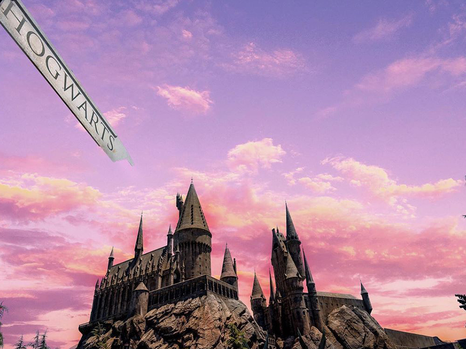 Hogwarts castle in a pink and purple sunset.