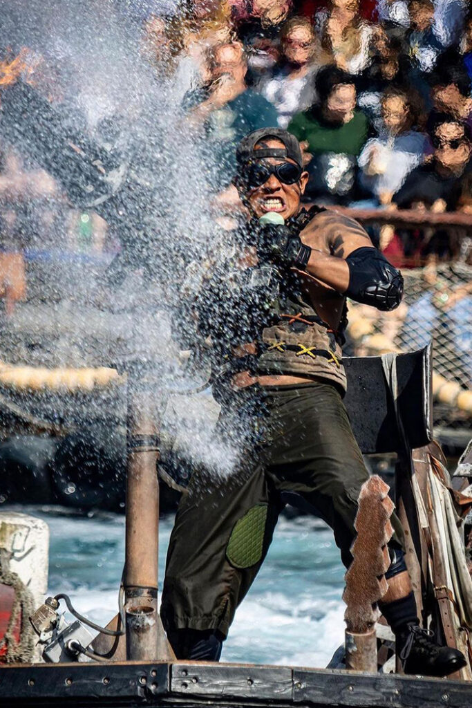 Waterworld performer shooting a water cannon.