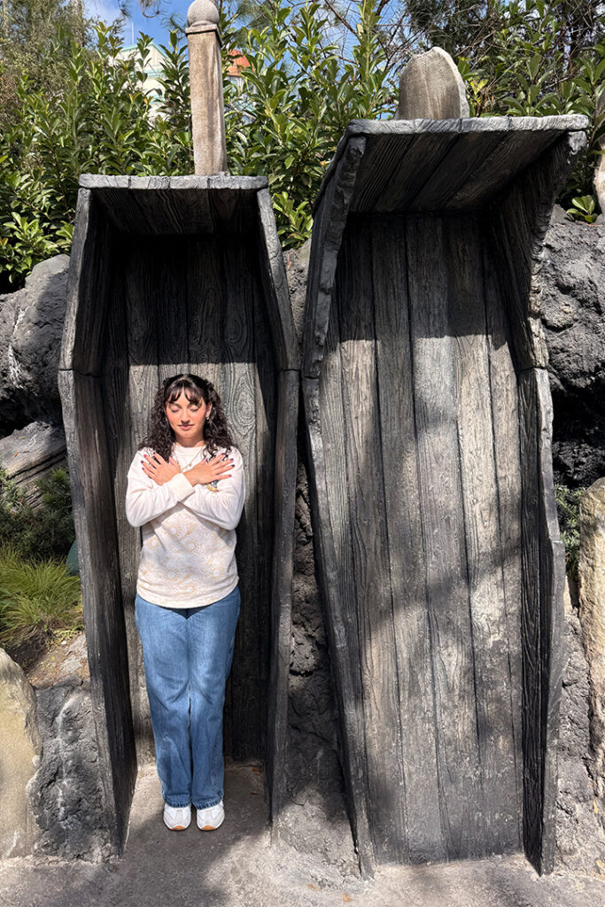 A ghost poses in the coffin photo op near the entrance of Dark Universe