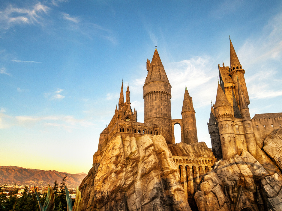 Exterior photograph of Hogwarts Castle during sunset. Exterior of Harry Potter and the Forbidden Journey in the Wizarding World of Harry Potter.