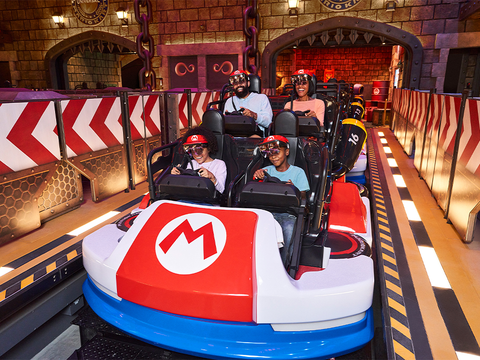 A family rides Mario Kart: Bowser's Challenge at SUPER NINTENDO WORLD.