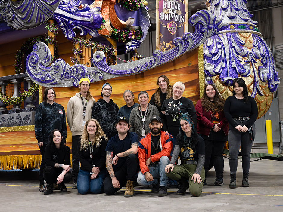 Team members in front of a Mardi Gras float