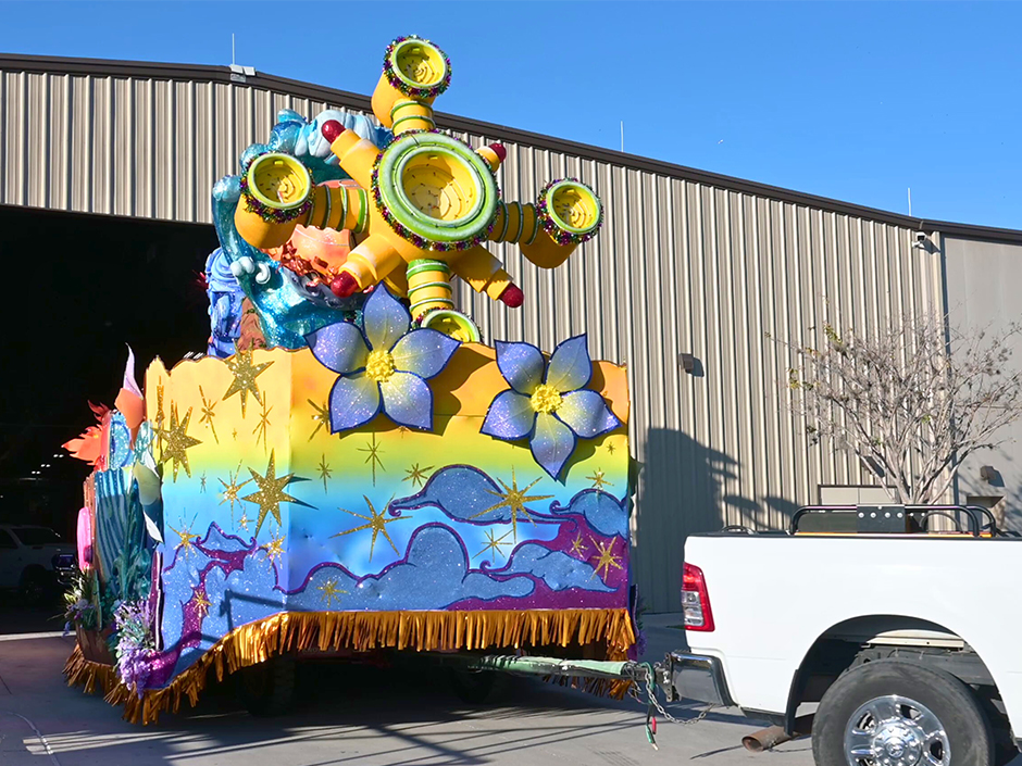 A Mardi Gras float towed by a truck