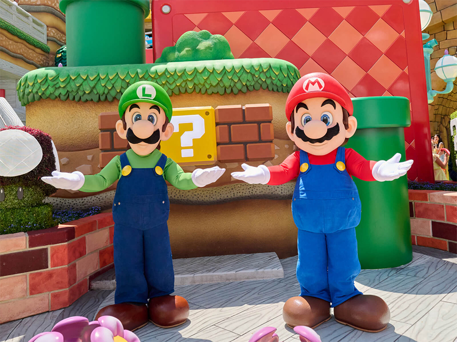 Mario and Luigi pose in front of a ?Block in SUPER NINTENDO WORLD