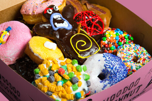 A box of colorful Voodoo Doughnuts.