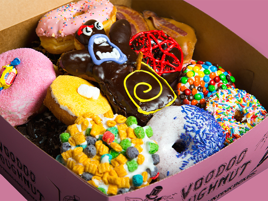 A box of colorful Voodoo Doughnuts.