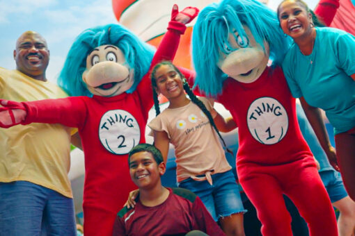 A family posing for a photo with Thing 1 and Thing 2.