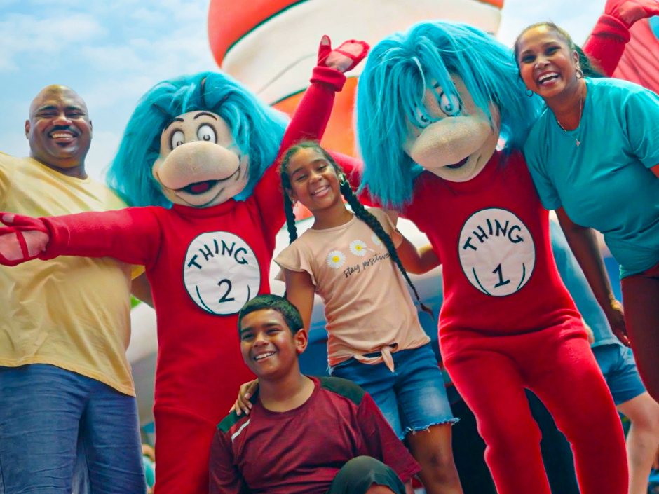 A family posing for a photo with Thing 1 and Thing 2.