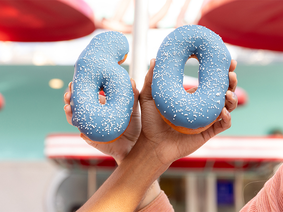 Two blue donuts shaped like 6 and 0, menu items for the Studio Tour 60th Anniversary celebration.