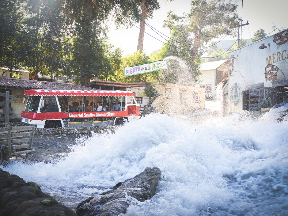 A tram drives by the Flash Flood on the Universal Studio Tour.