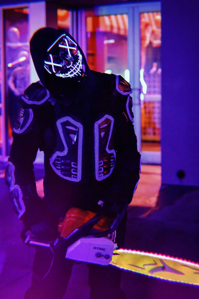 A Halloween Horror Nights scareactor holds a chainsaw