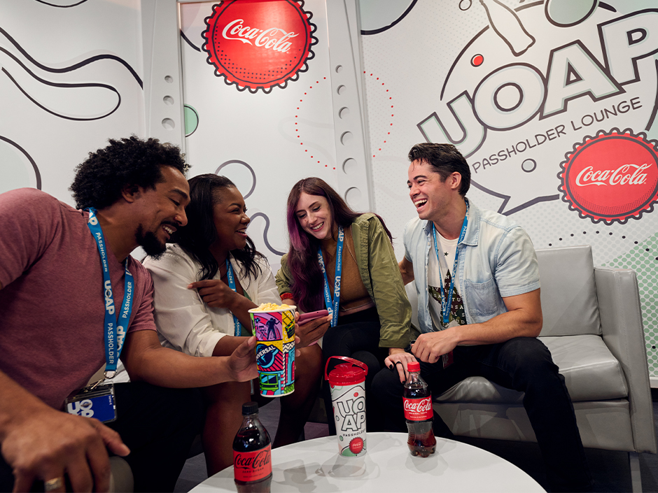 A group of friends smiling in the UOAP Passholder Lounge.