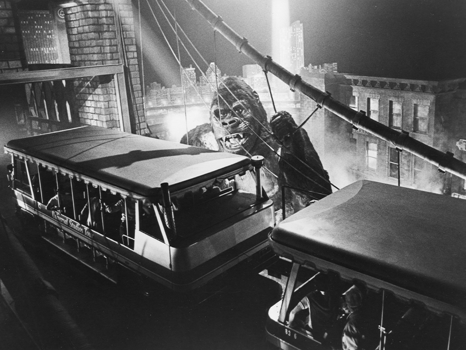 A black and white photo of King Kong visiting a Universal Studio Tour tram.