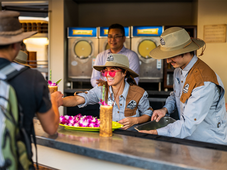 Two bartenders serve tiki cocktails at Isla Nu Bar in the Jurassic World section of Universal Studios Hollywood.