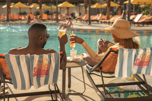 A couple sits by the pool at Universal Endless Summer Resort